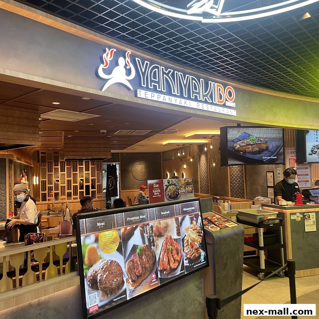 The exterior of Yaki Yaki Bo Teppanyaki Restaurant with a digital menu displaying food items.