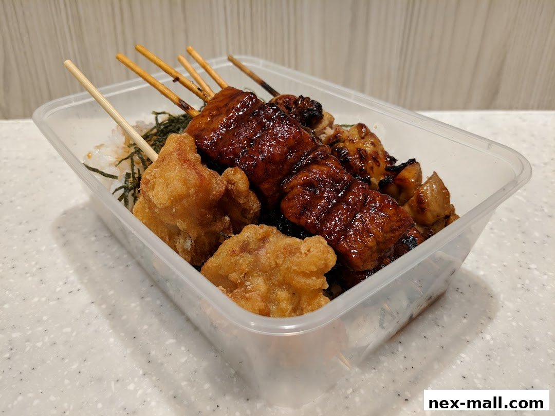 A takeaway container filled with assorted grilled skewers and fried chicken pieces.