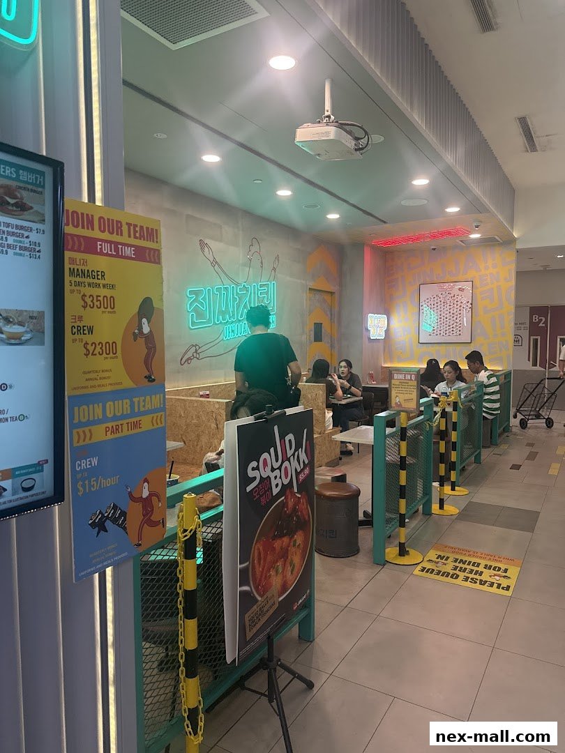 Interior view of JINJJA Chicken restaurant with a queue line and recruitment posters.