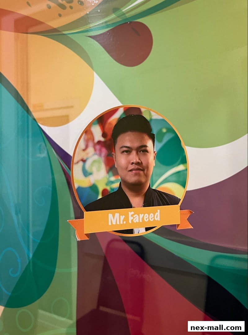 A portrait of Mr. Fareed with a colorful, abstract background.