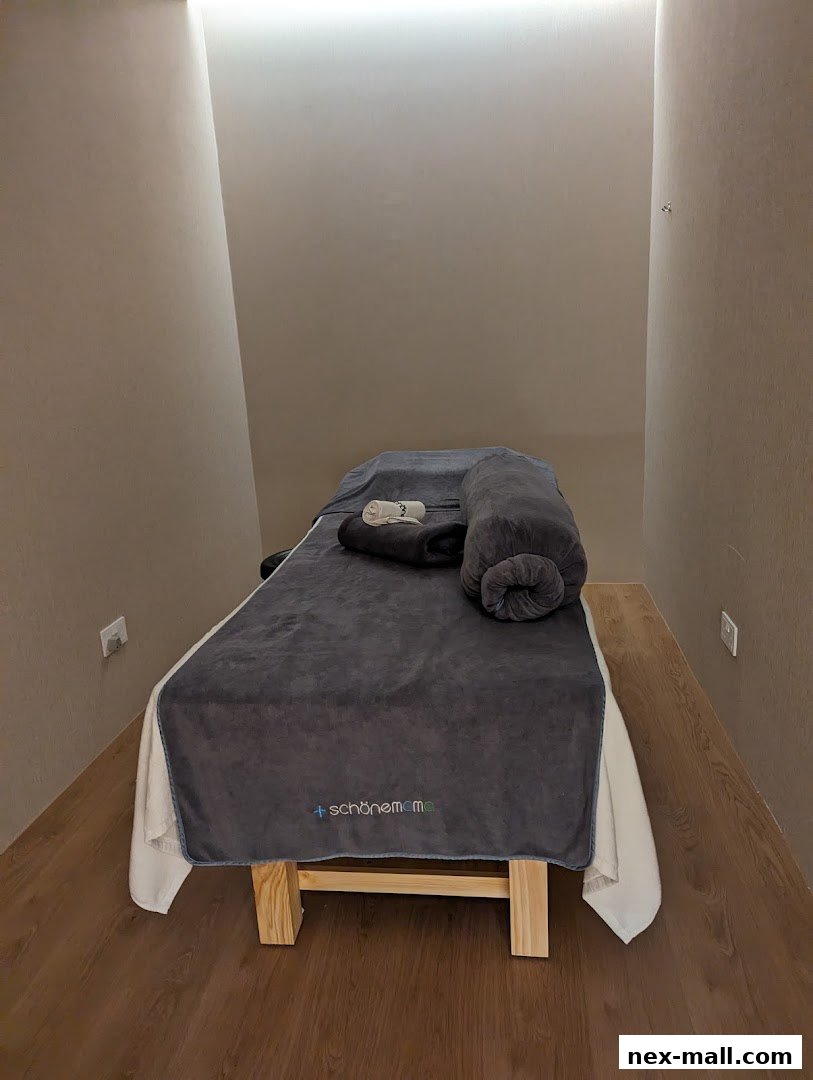 A massage table with a bolster and towels, ready for a treatment.