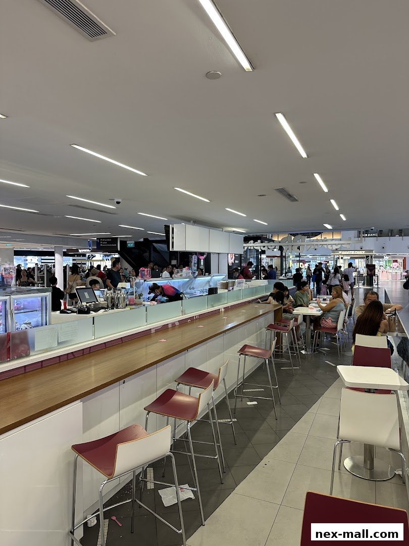 Interior view of a Baskin-Robbins ice cream shop with a long counter and seating area.