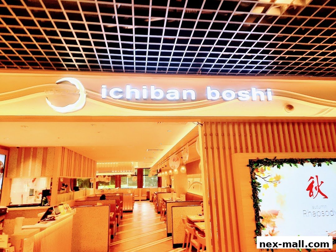 The interior of Ichiban Boshi NEX restaurant with seating and the shop's sign.