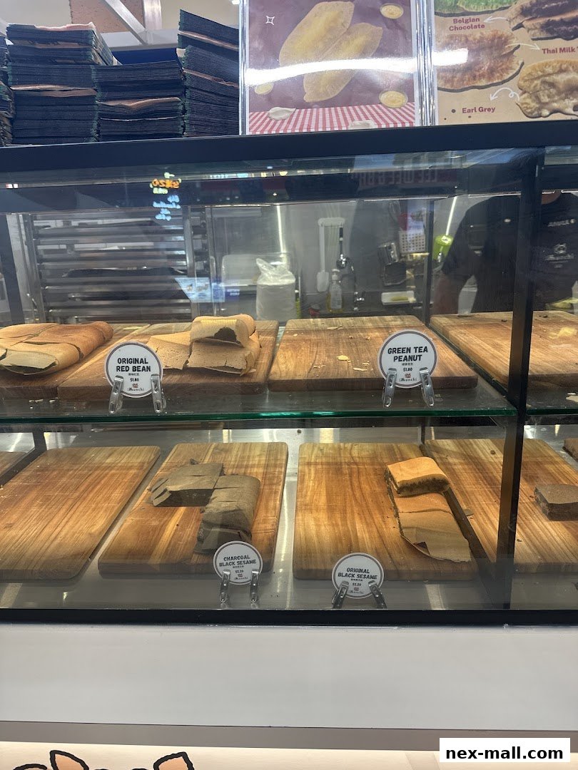 A display case filled with various flavors of pancakes, showcasing different fillings and toppings.
