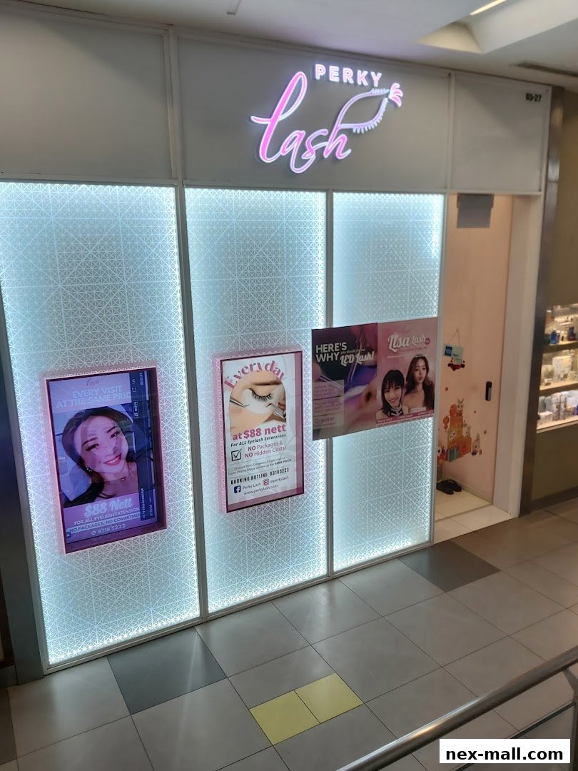 The Perky Lash shop front with illuminated panels and promotional posters.