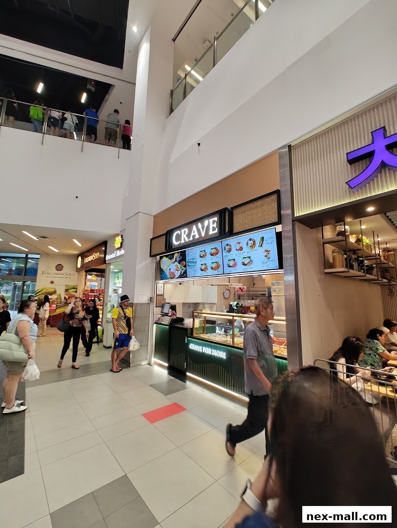 A Crave Nasi Lemak shop with a digital menu board and customers queuing.