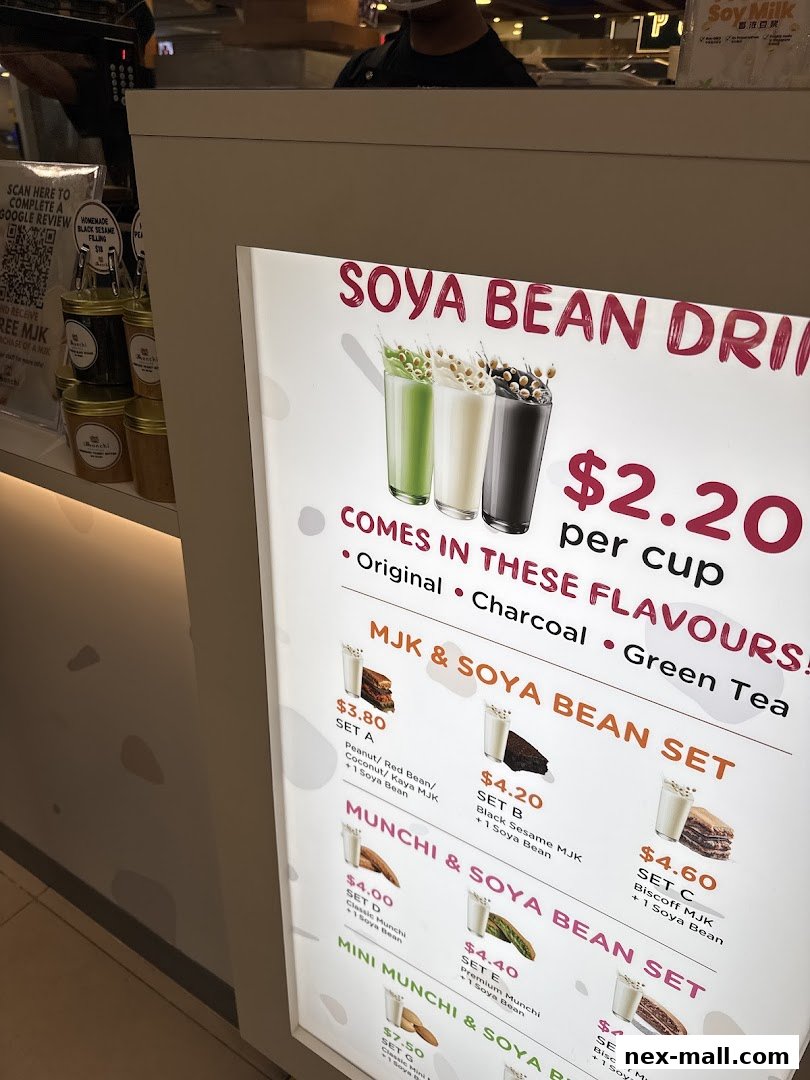 A brightly lit menu board showcasing various soya bean drinks and sets with prices.