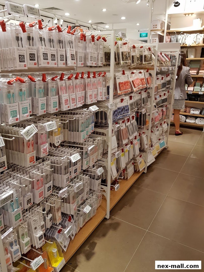 A wide selection of charging cables and phone accessories displayed on shelves in a retail store.