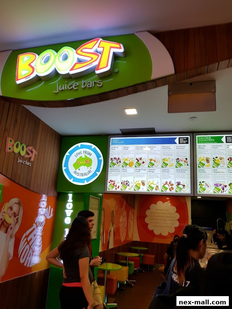 Interior view of a Boost Juice bar with a prominent sign and menu boards.