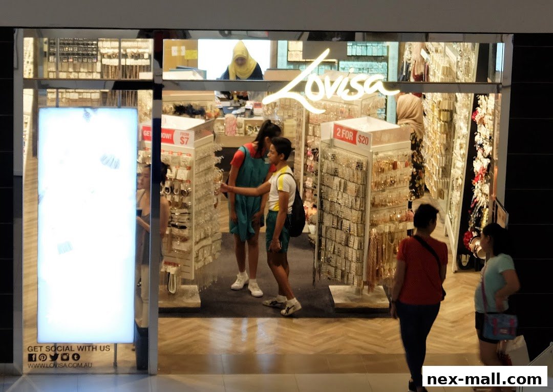 People browsing jewelry displays inside a brightly lit Lovisa store.