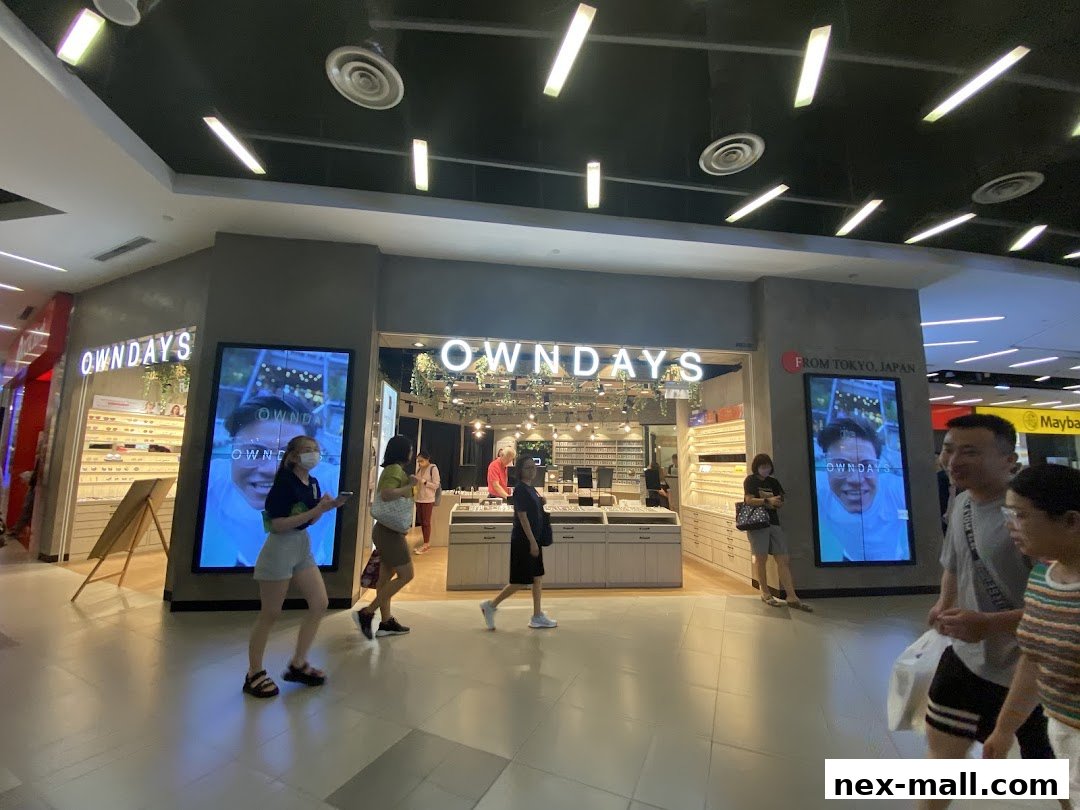 The OWNDAYS nex shop front displays eyewear and digital screens with smiling faces.