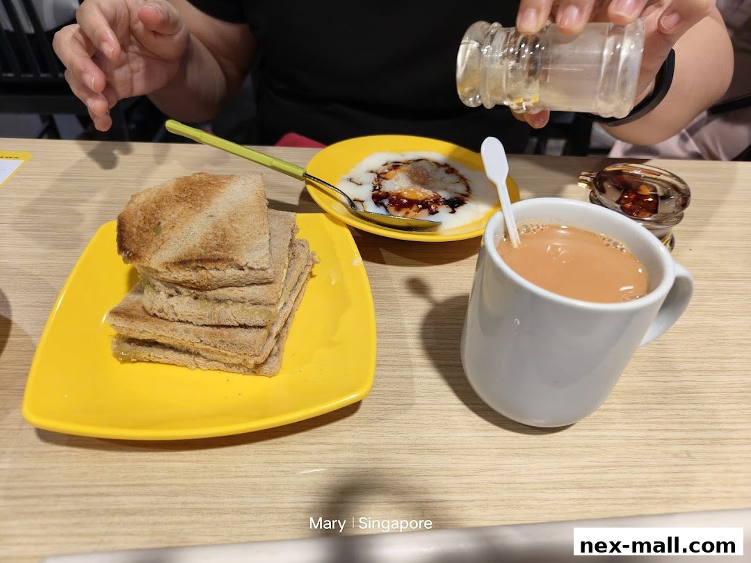 A close-up of a breakfast set with toast, soft-boiled eggs, and a cup of tea.
