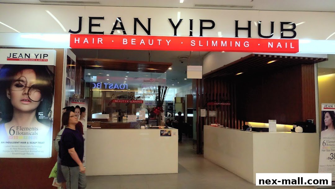 The entrance of Jean Yip Hub, a hair and beauty salon, with promotional posters.