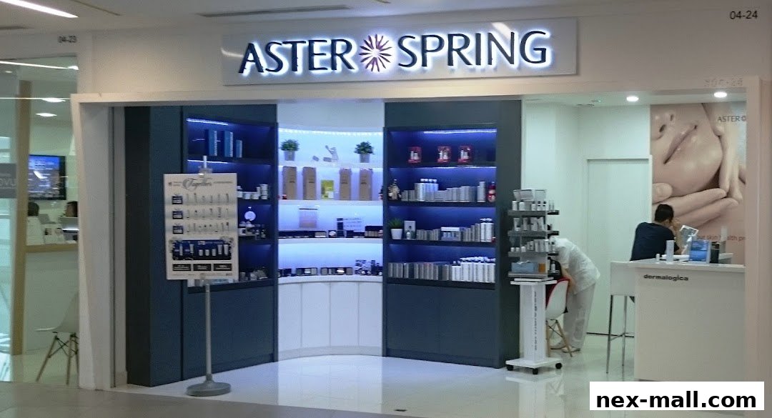 The entrance of AsterSpring NEX, a beauty and skincare shop, showcasing products and a consultation area.