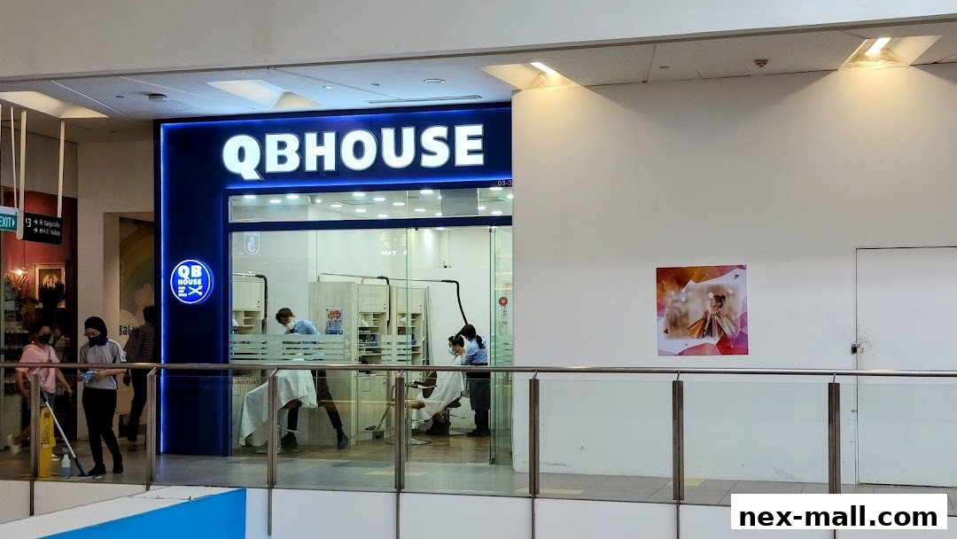 QB HOUSE NEX storefront with barbers cutting hair inside.