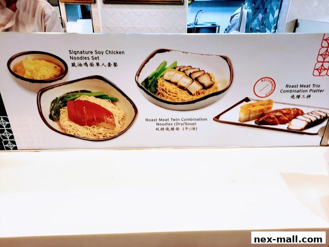 A menu board displaying various noodle and meat combination dishes from Food Junction.