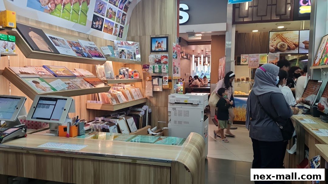 Interior view of a FotoHub shop with displays of photos, books, and a counter with customers.