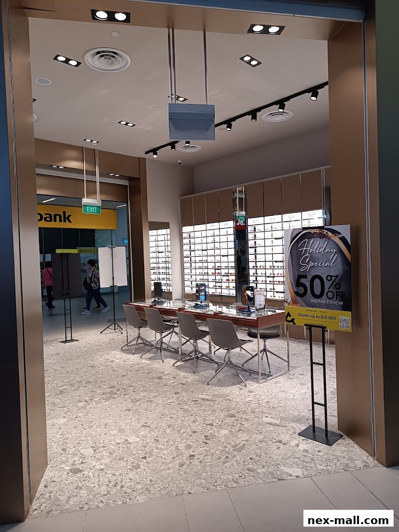 The entrance to Spectacle Hut NEX, showcasing eyewear displays and a holiday special offer.