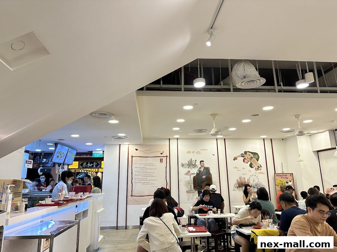 Interior view of a busy Ya Kun Kaya Toast restaurant with customers dining and staff serving.