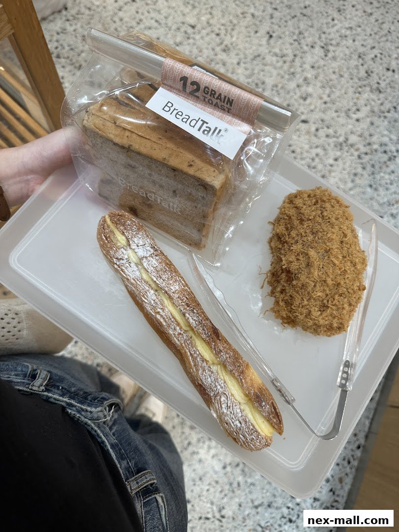 A tray with assorted baked goods from BreadTalk, including toast and a filled pastry.