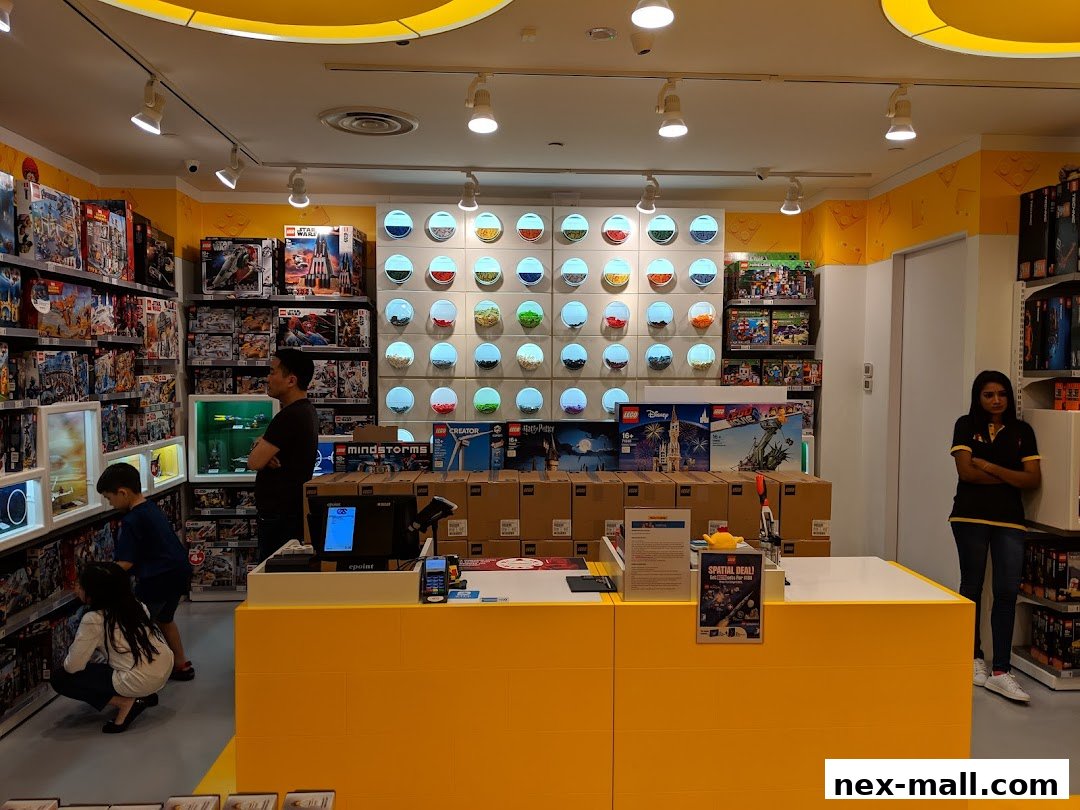 Interior of a LEGO store with shelves full of LEGO sets and a checkout counter.