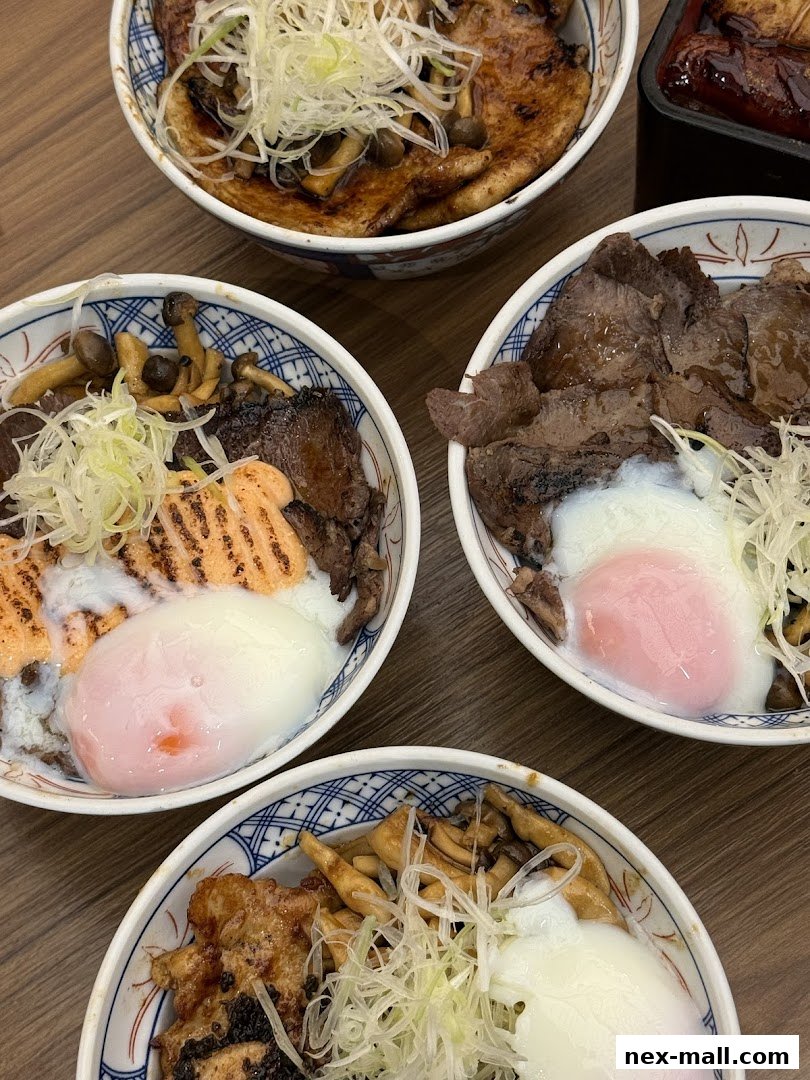 A close-up shot of four delicious Japanese rice bowls with various toppings.