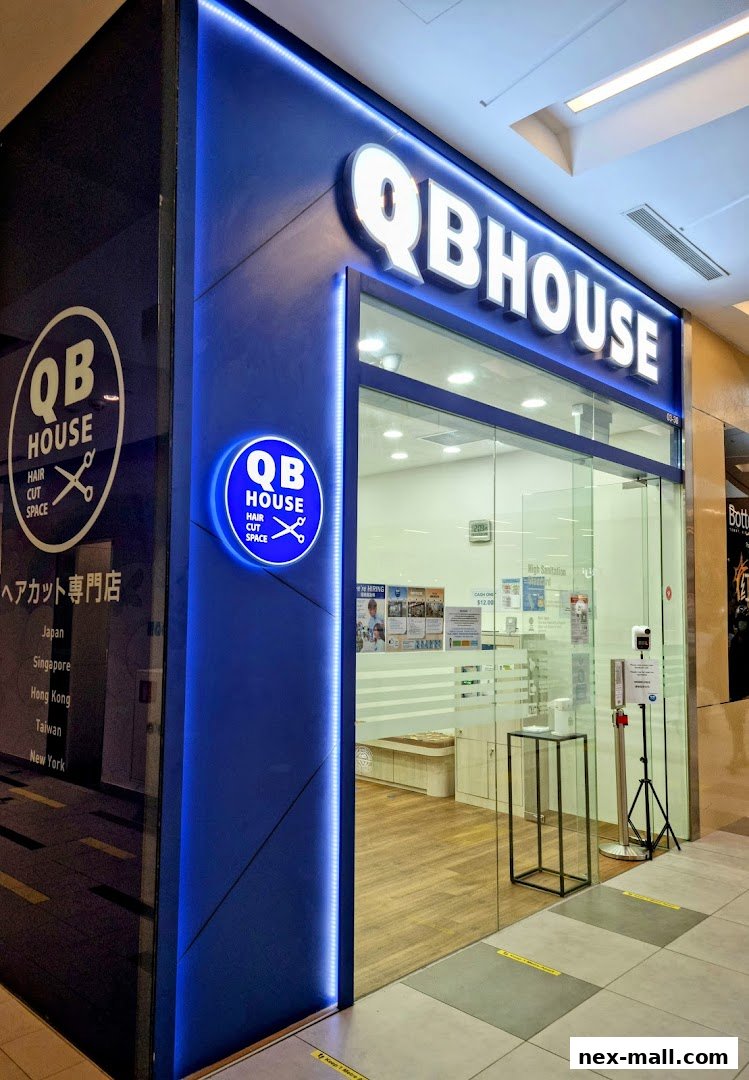 The exterior of a QB House hair salon with a prominent blue and white sign.