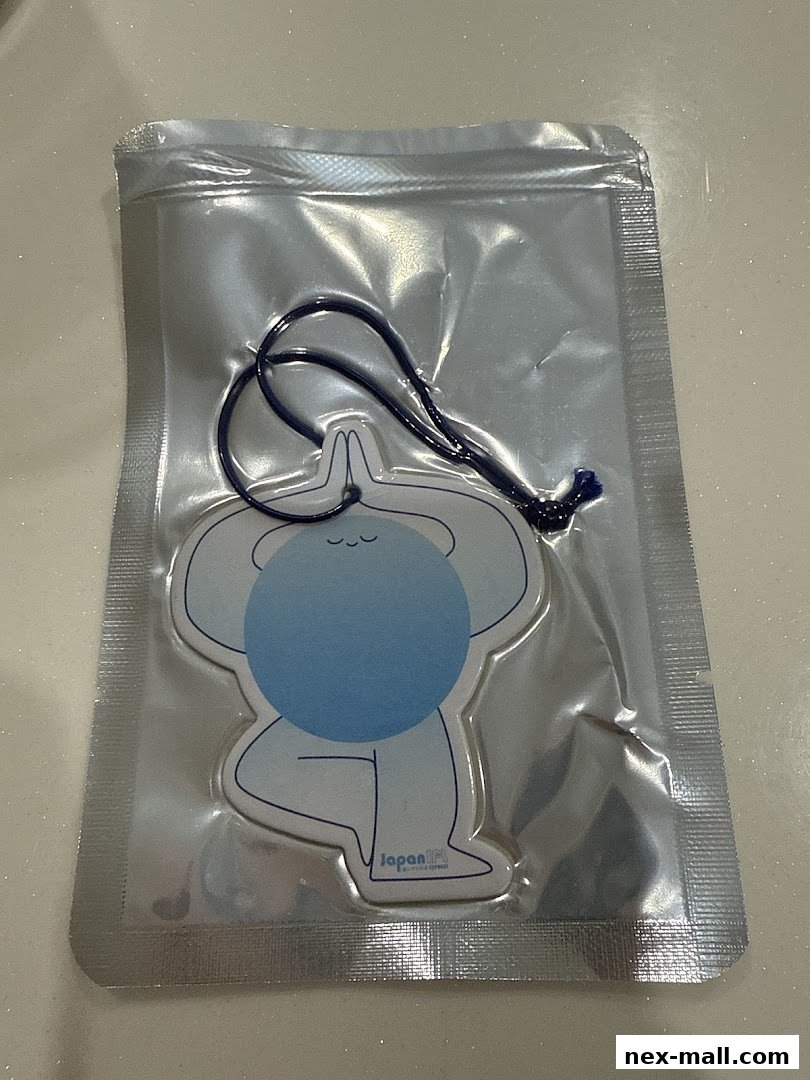 A packaged air freshener with a cartoon yoga figure and the Japan IPL Express logo.
