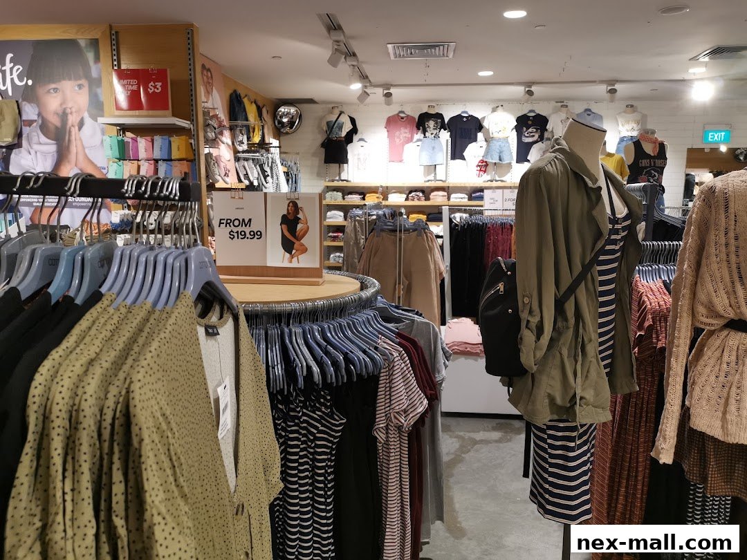 Interior view of a Cotton On store showcasing clothing racks and mannequins with stylish outfits.