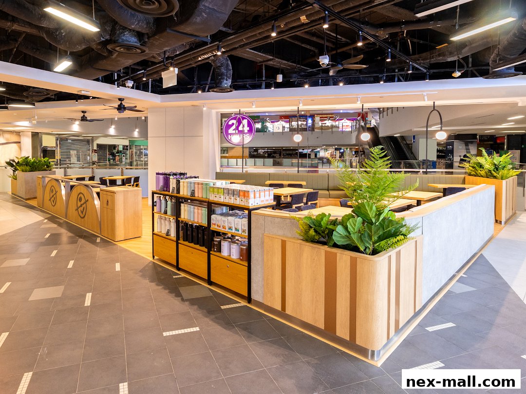 Interior view of The Coffee Bean Tea Leaf cafe with seating, merchandise, and a 24-hour sign.