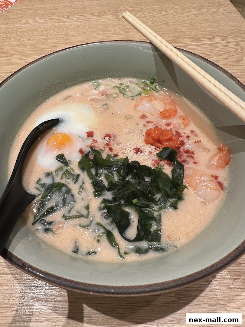 A close-up shot of a delicious bowl of ramen with shrimp, egg, and seaweed.
