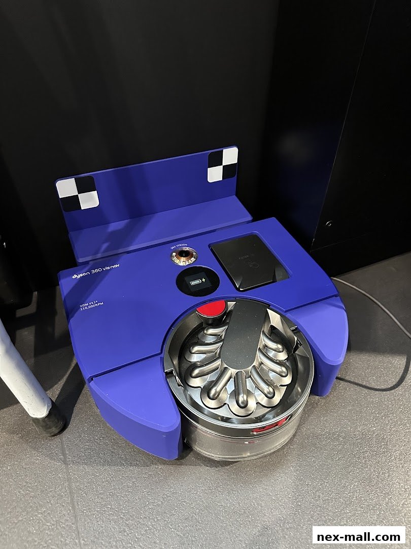 A purple Dyson 360 VisNav robot vacuum cleaner is displayed on a gray floor.