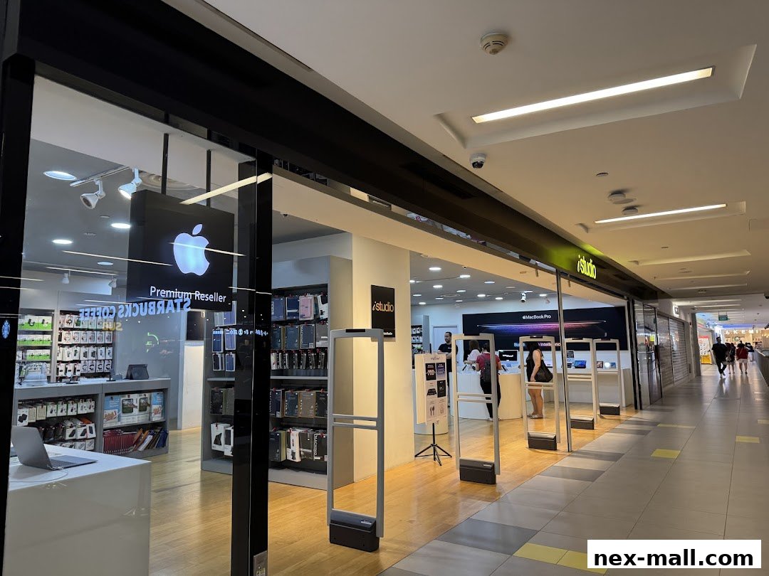The entrance of an iStudio store, a premium Apple reseller, showcasing Apple products and accessories.