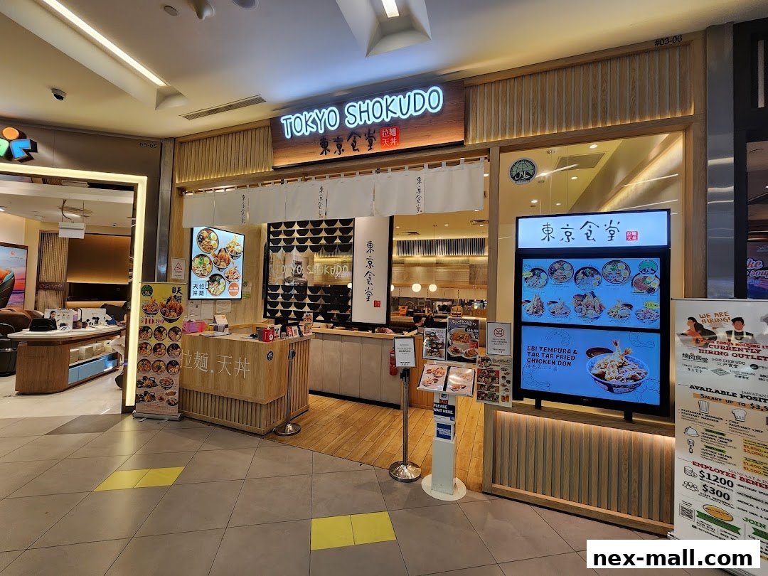 The exterior of Tokyo Shokudo, a Japanese restaurant, with digital menus and a hiring advertisement.