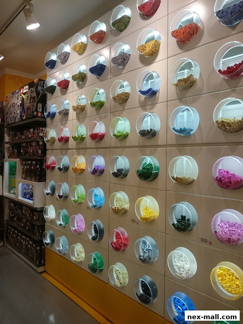 Wall display of colorful LEGO bricks in circular containers at The Brick Shop.