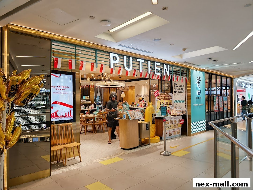 The entrance of PUTIEN restaurant, decorated with Singapore flags and promotional posters.
