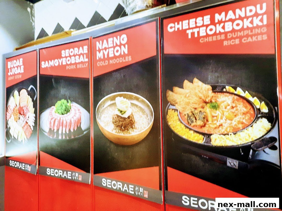 A display of Korean dishes including Budae Jjigae, Samgyeopsal, Naengmyeon, and Cheese Mandu Tteokbokki.