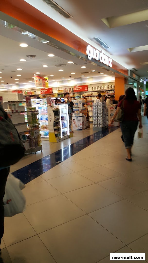 Interior view of a Guardian Health & Beauty store with products on shelves and customers browsing.