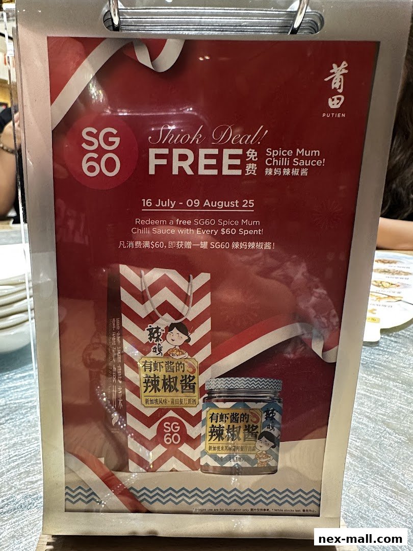 A promotional sign for PUTIEN NEX offering a free Spice Mum Chilli Sauce with every $60 spent.