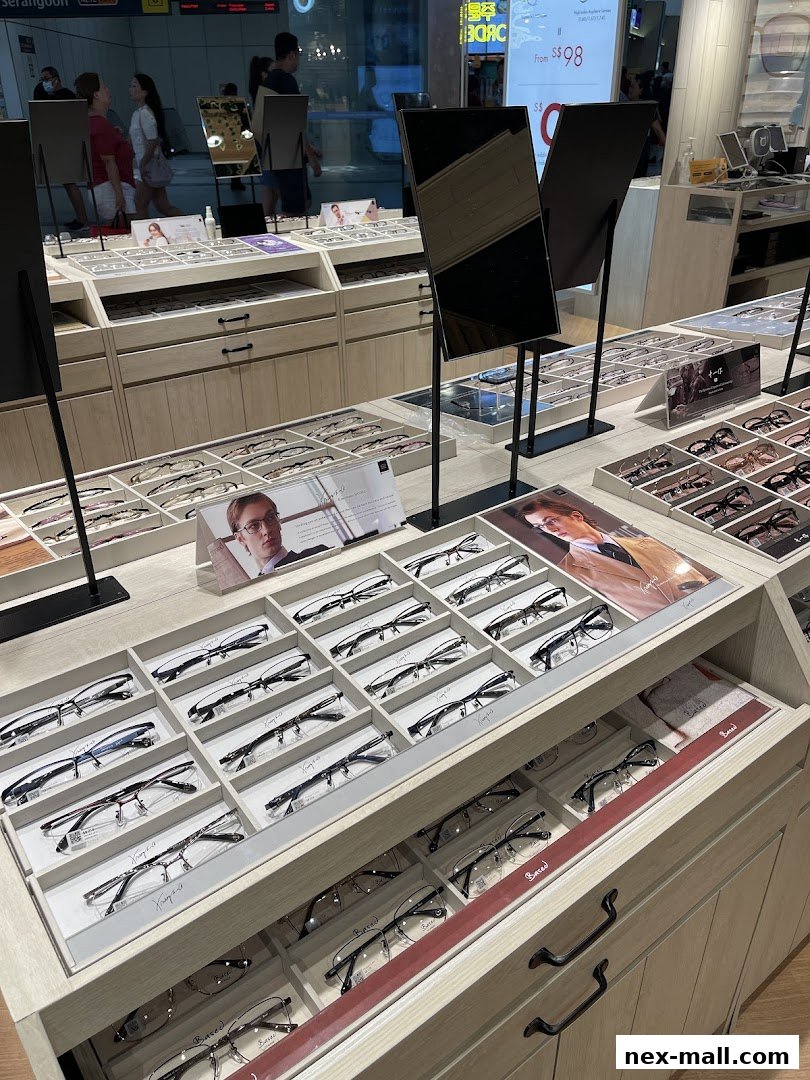 A display of various eyeglasses in a retail store, with mirrors and promotional material.