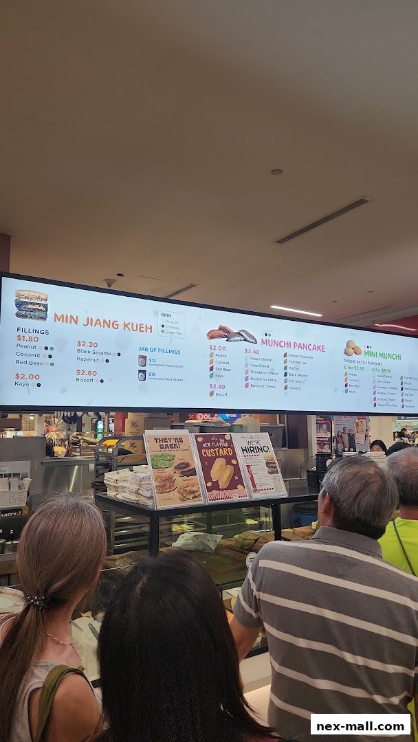 A menu board displaying various pancake fillings and flavors at Munchi Pancakes.