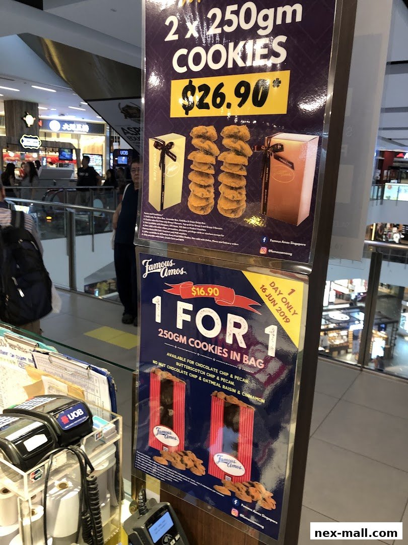 Promotional posters for Famous Amos cookies, advertising a 2 for $26.90 deal and a 1 for 1 offer.