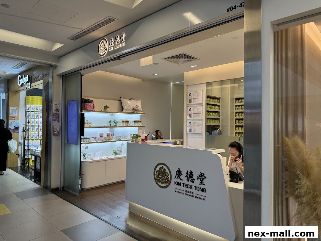 The entrance and counter of Kin Teck Tong TCM Clinic, showcasing products and staff.