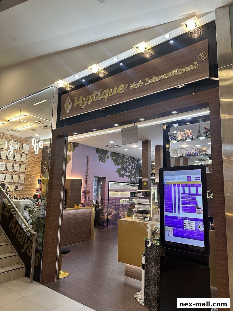 The entrance of Mystique Hub International, a nail salon, with a digital display showcasing services.