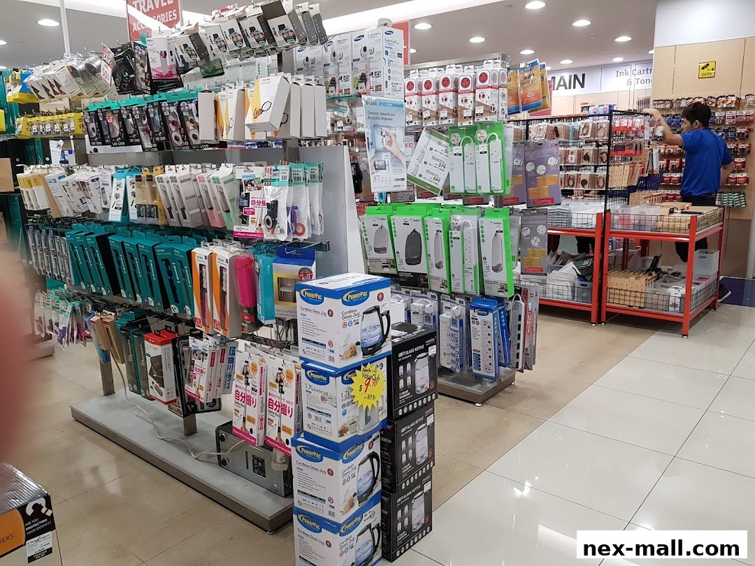Interior view of a Challenger NEX electronics store with various accessories and appliances on display.