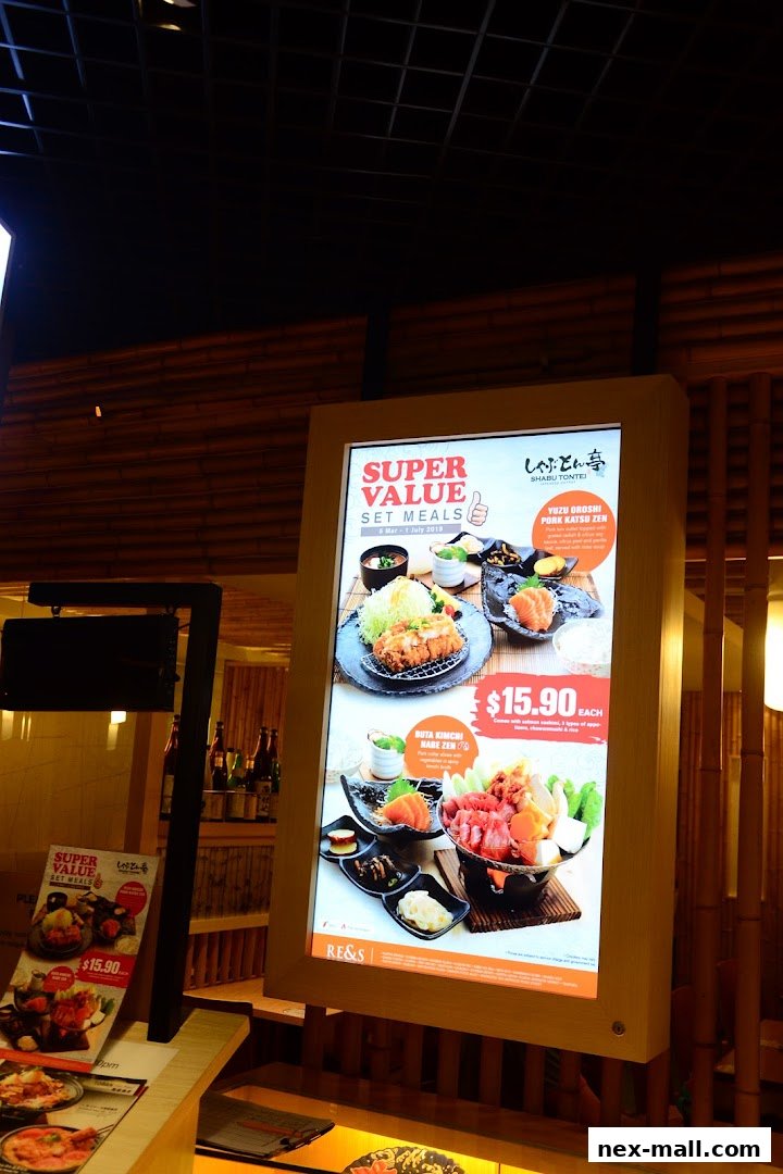 A digital menu board showcasing Japanese set meals with prices and enticing food photography.