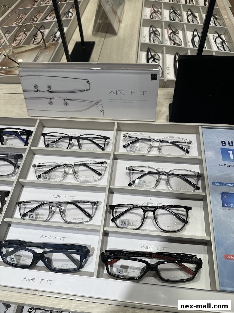A display of various eyeglasses, featuring the 'AIR FIT' brand, in a retail store setting.