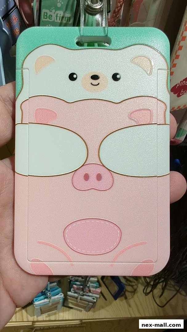 A hand holds a cute pink and white pig and bear themed ID card holder.