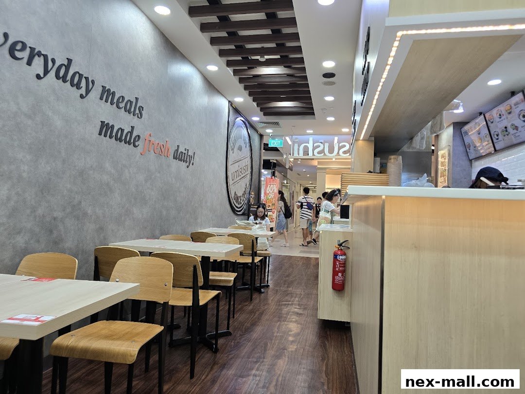 Interior of a sushi restaurant with tables, chairs, and a counter.