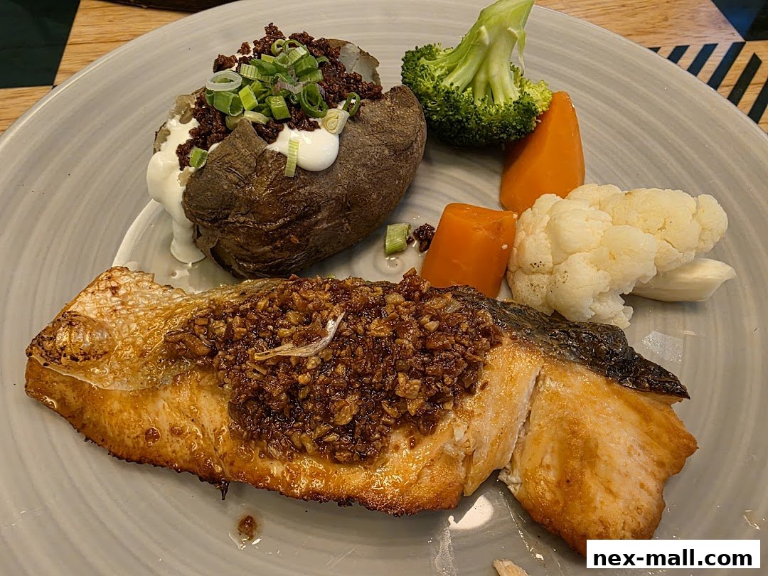 A delicious plate of grilled salmon with a baked potato and mixed vegetables.